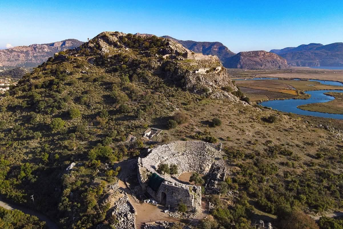 Kaunos ancient theatre on the hillside with the Dalyan delta and winding river visible below