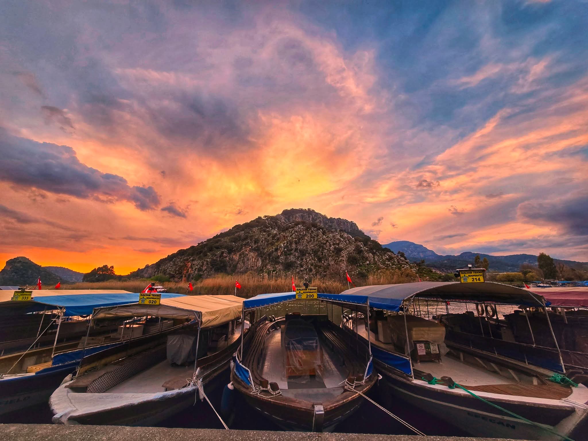 Dalyan houses at sunset with the mountains behind, warm golden light
